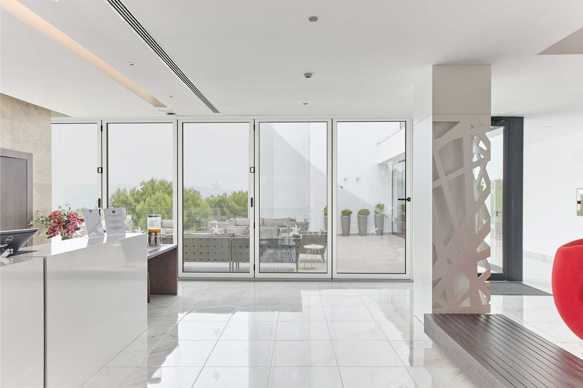 white bifold doors in a modern white kitchen